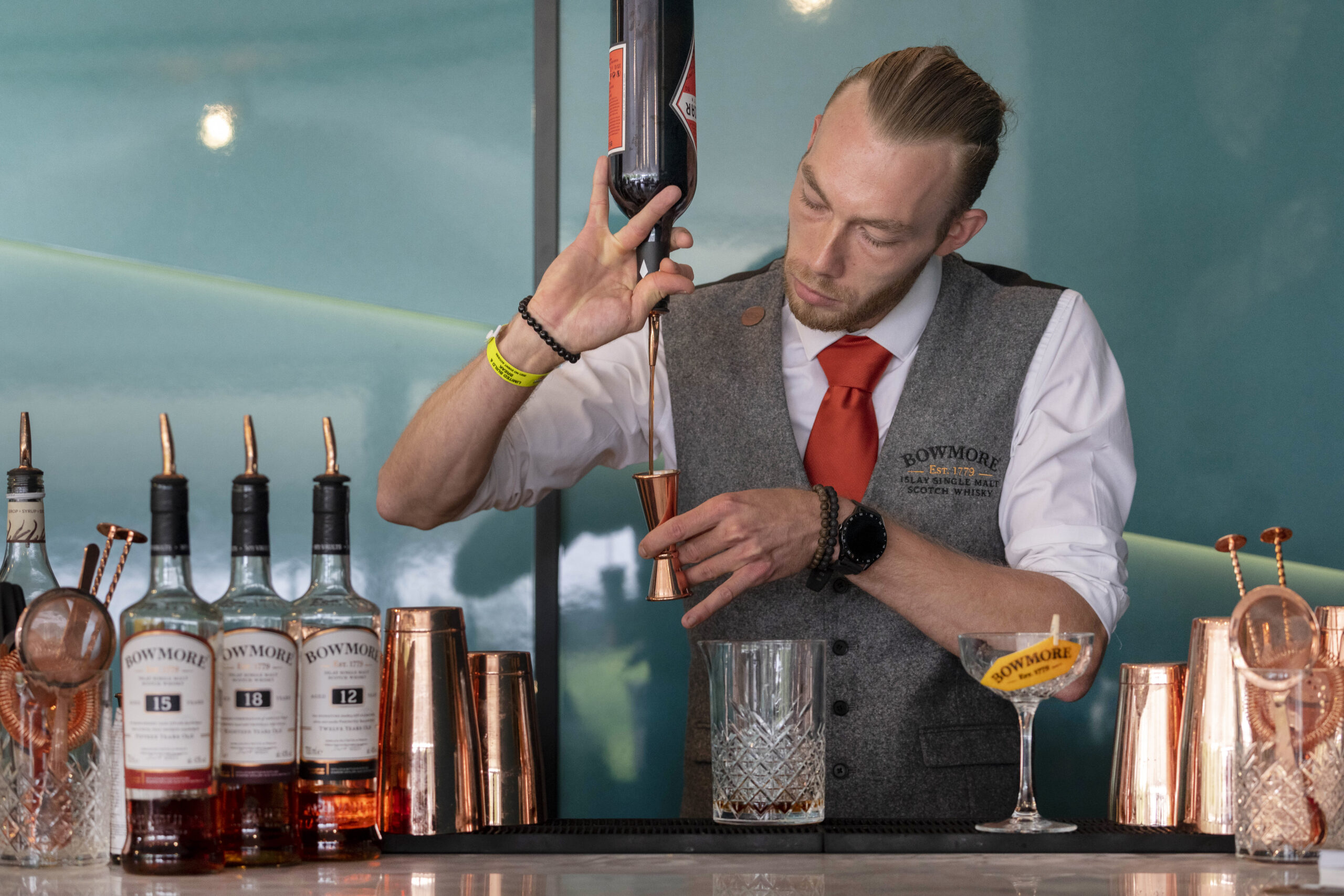 A mixologist from The Cocktail Service at an activation for Bowmore Whisky in the Aston Martin marquee at Goodwood Festival 2021