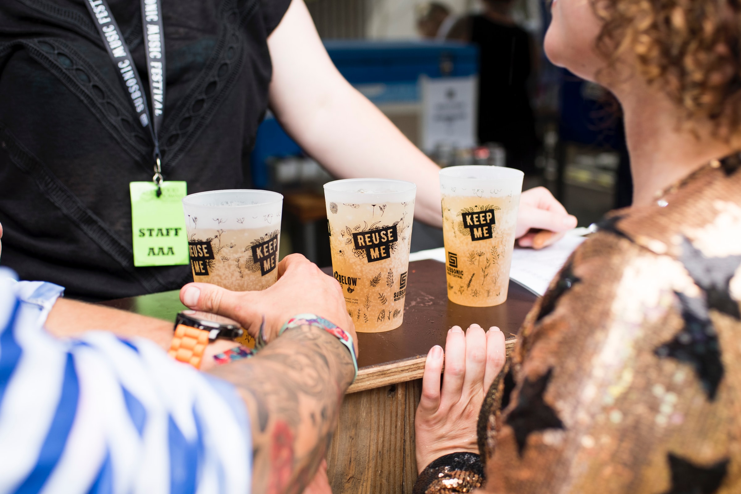 Three drinks in plastic reusable cups at Subsonic Music Festival, Sydney Australia. Are festivals worthwhile to brands? Photo by Globelet Reusable on Unsplash