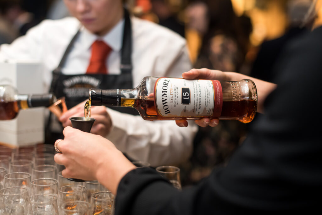 TCS bartenders serving Bowmore Whisky at an activation for the Masters' Selection