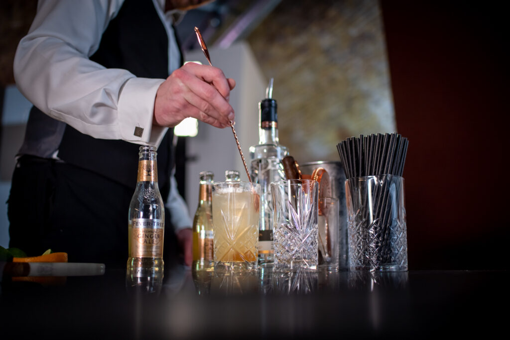A TCS bartender mixing a cocktail at a photoshoot