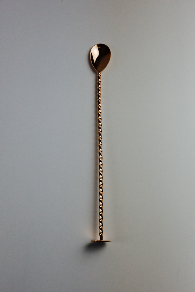 A copper bar spoon